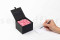 An elegant black box filled with preserved pink roses